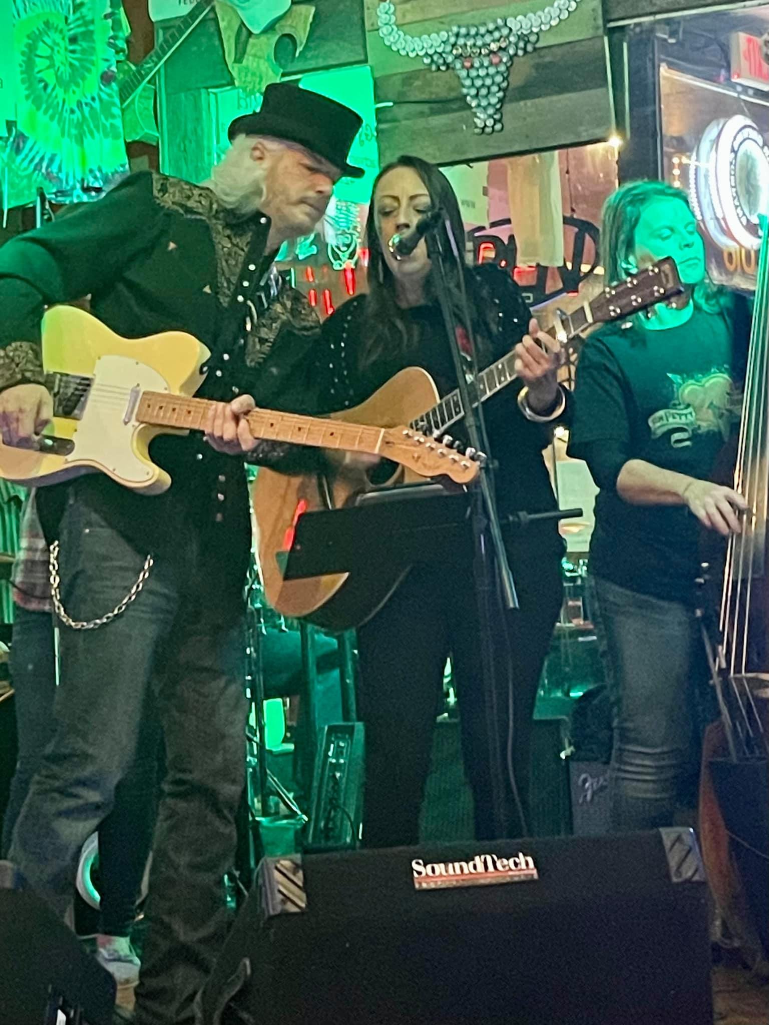 Julie Williams singing while playing guitar