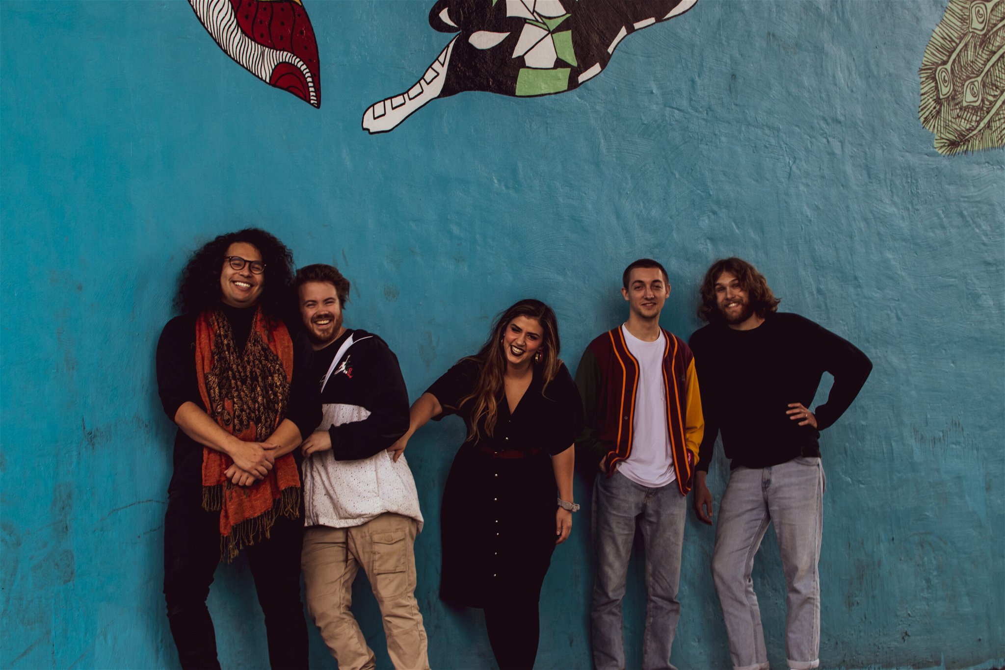 Florencia & The Feeling - The band members standing and laughing together, creating a joyful and lively atmosphere. They will be preforming for Music in the Village with Florencia & the Feeling at beech Mountain resort.